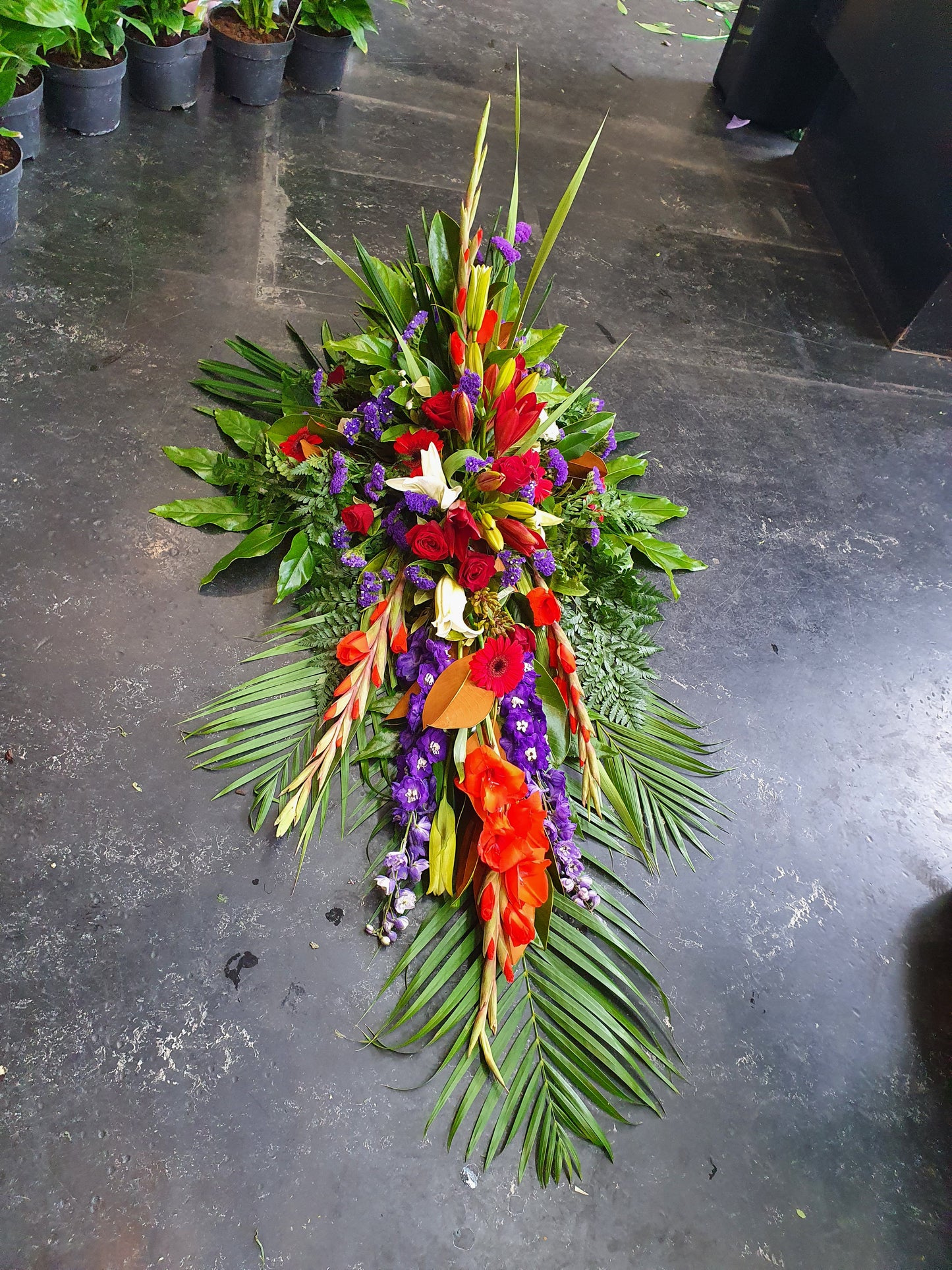 Gorgeous foliage and flowers help create texture and interset to these stunning traditional casket sprays